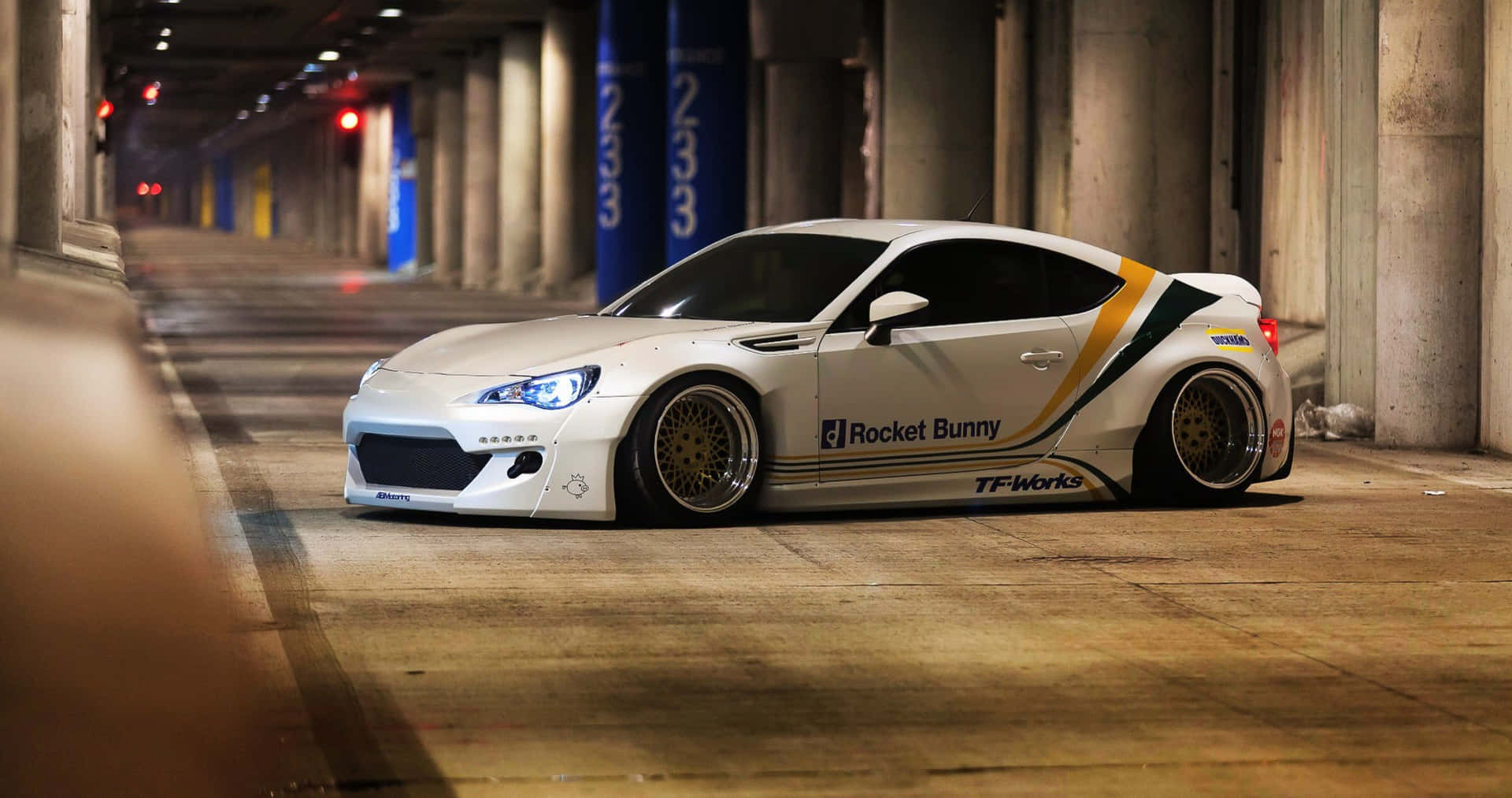 A White Sports Car Is Parked In A Tunnel Background
