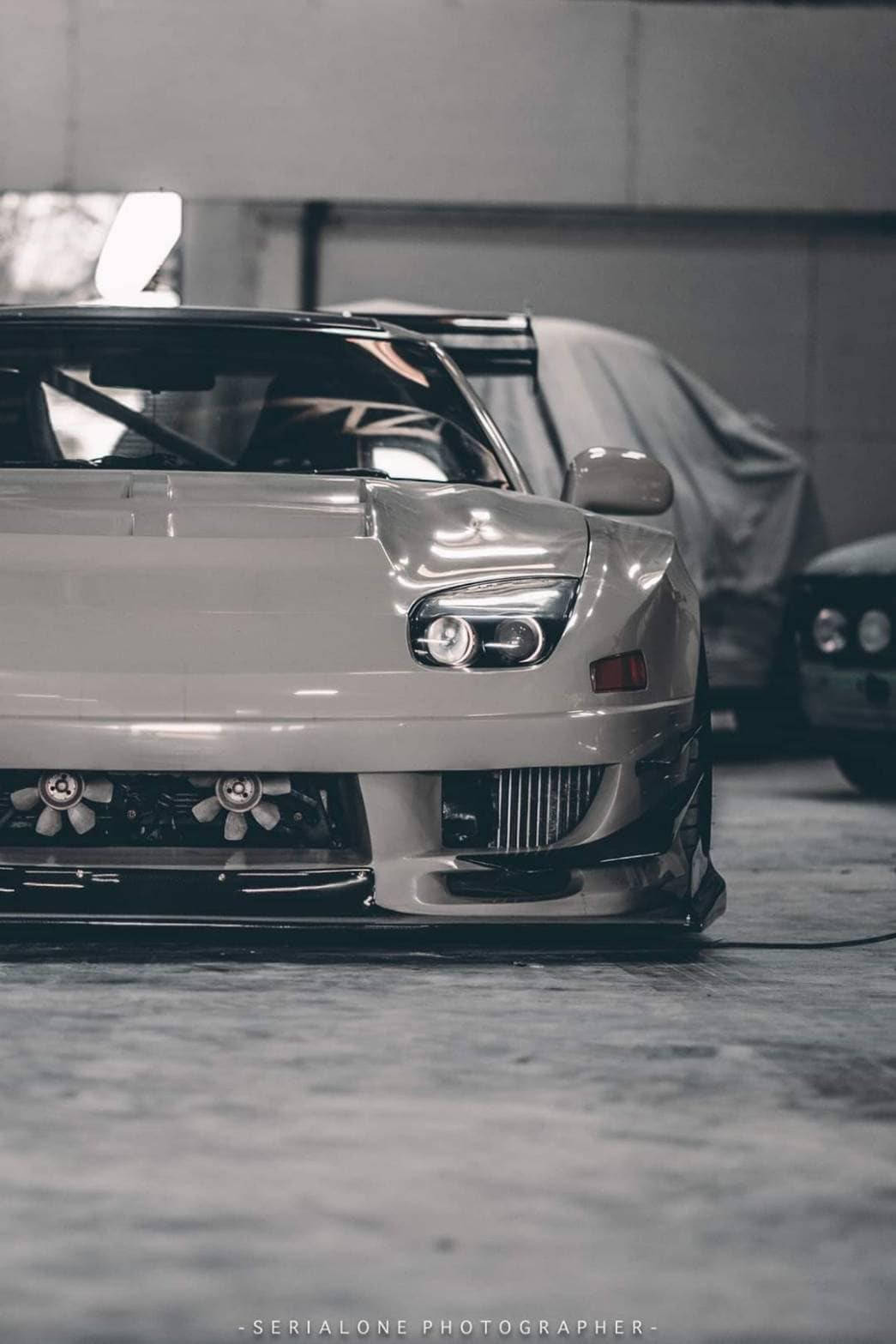 A White Sports Car Parked In A Garage Background