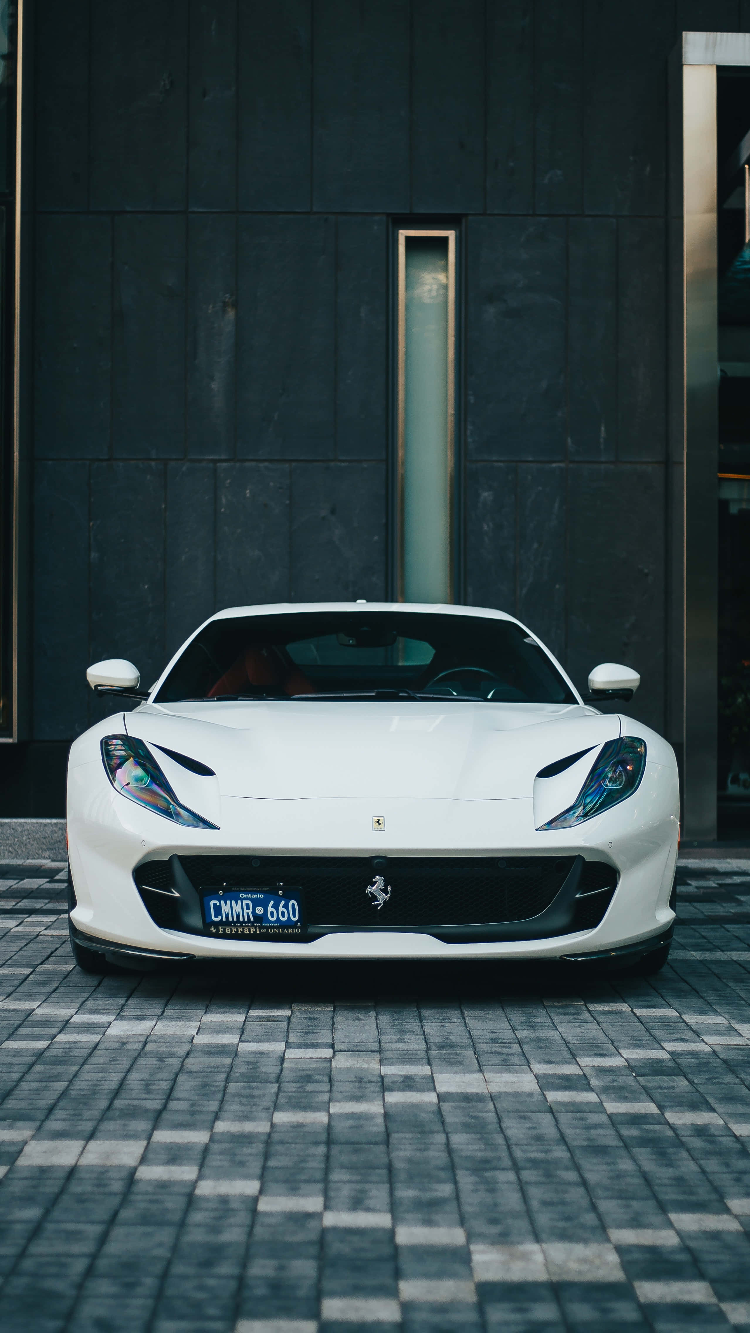 A White Sports Car Parked In Front Of A Building Background