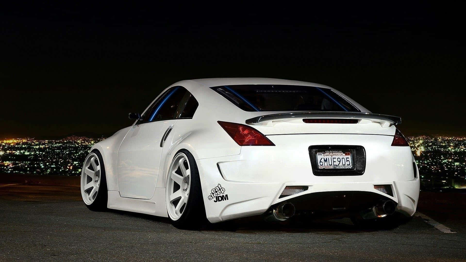 A White Sports Car Parked In Front Of A City Background