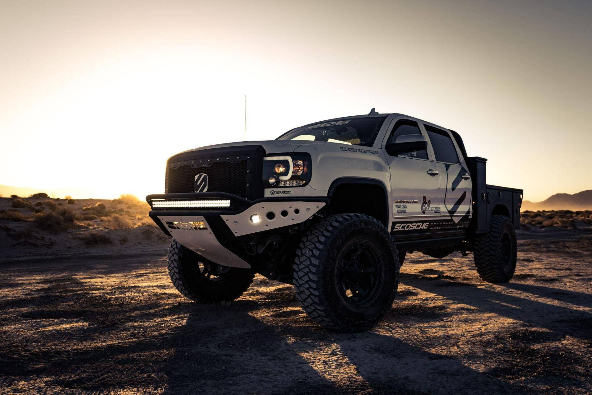 A White Truck Is Parked In The Desert