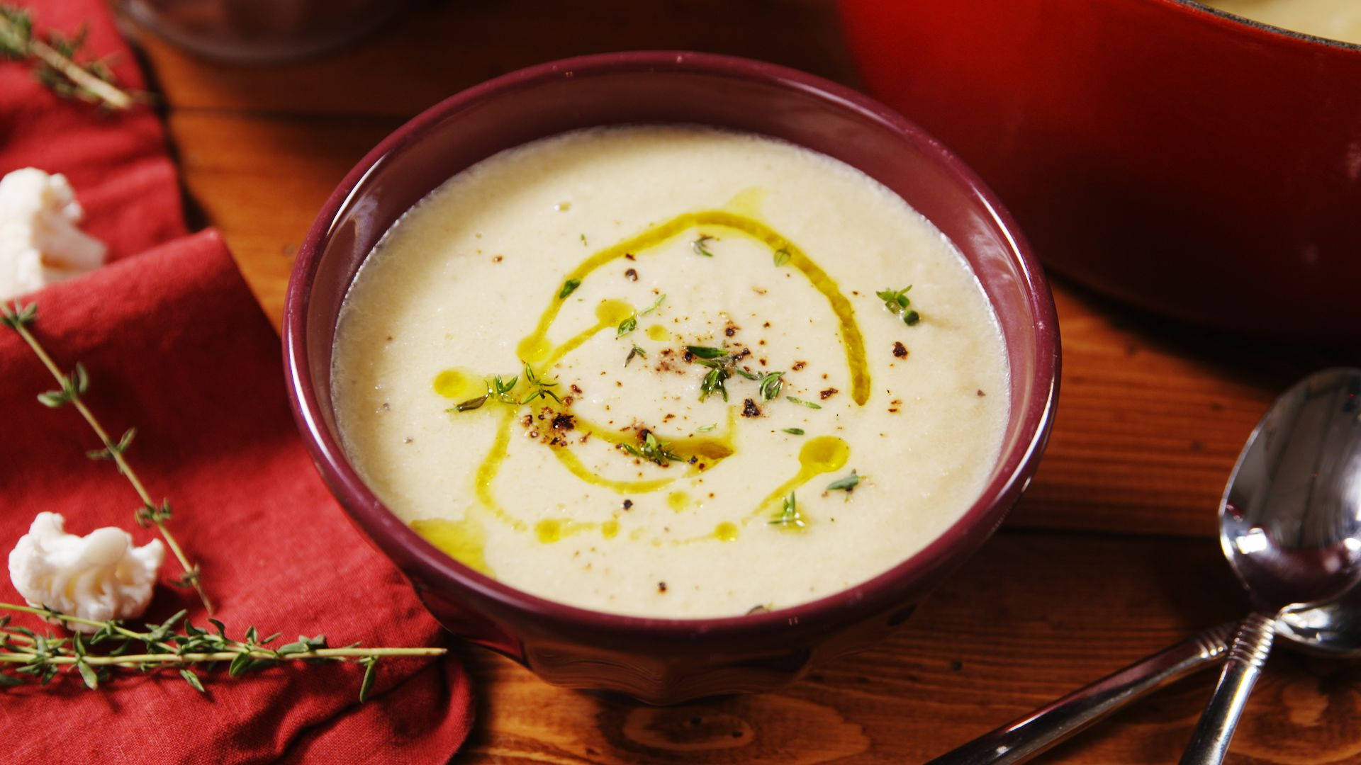 A Wholesome Bowl Of Cauliflower Soup In A Red Bowl. Background