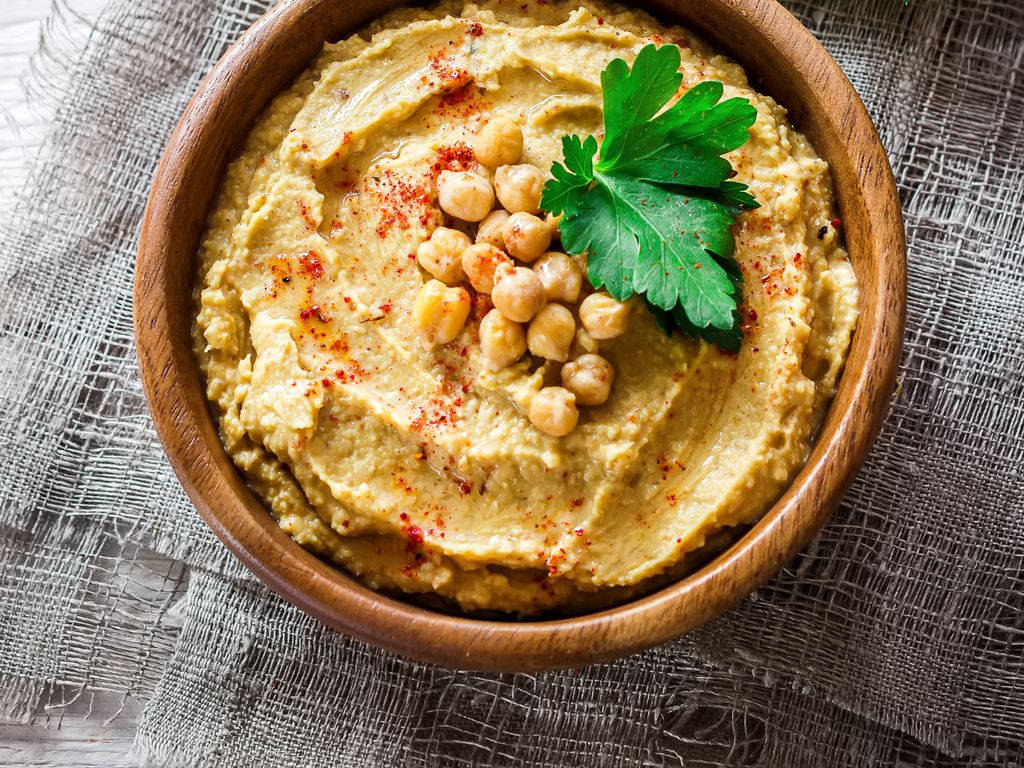 A Wholesome Plate Of Hummus Sprinkled With Paprika And Garnished With Chickpeas