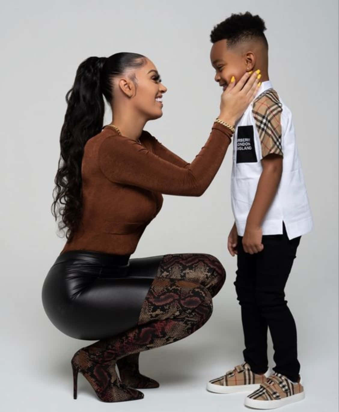 A Woman And A Child Are Posing For A Photo Background