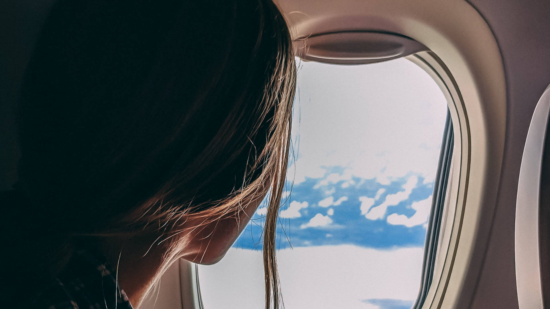 A Woman Beside A Plane Window