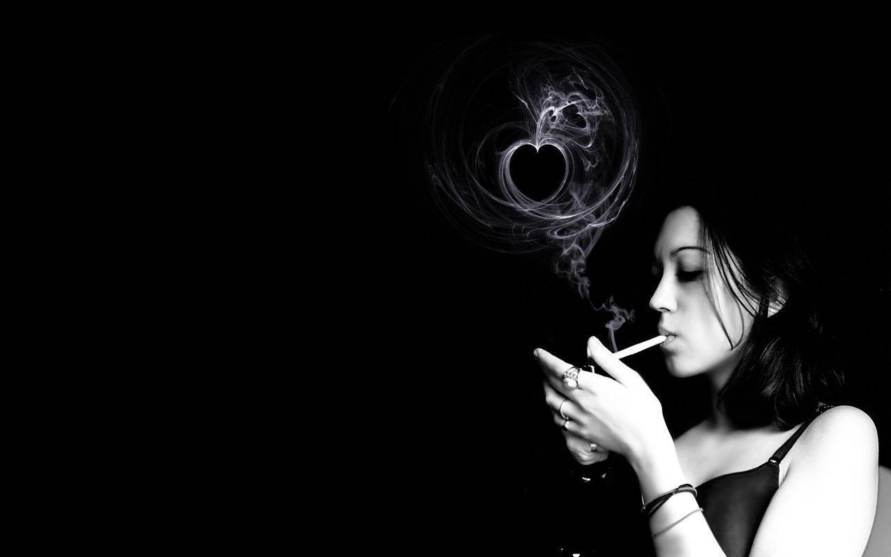A Woman Breathing Out Heart-shaped Smoke
