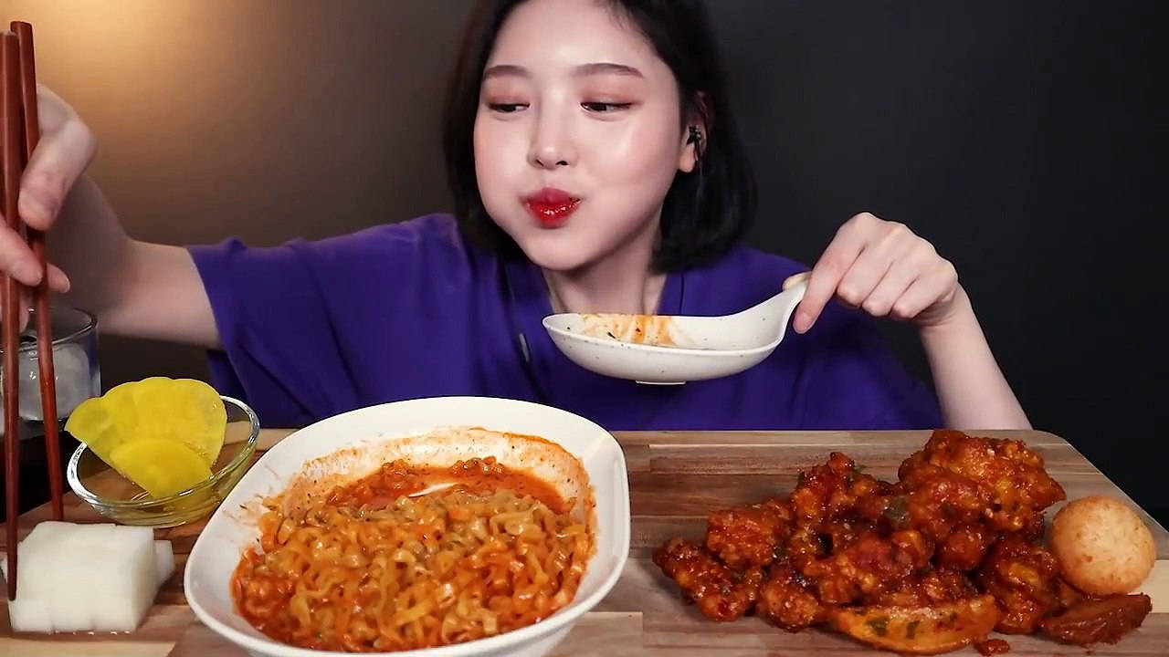 A Woman Eating A Bowl Of Food With Chopsticks Background