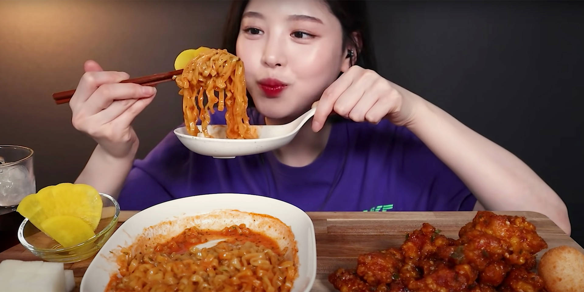 A Woman Eating Noodles With A Spoon