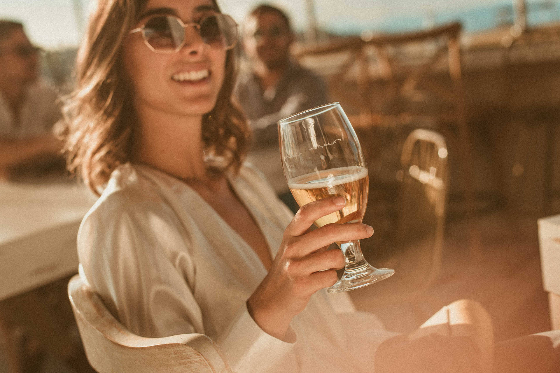 A Woman Enjoying A Cold Beer On A Hot Day