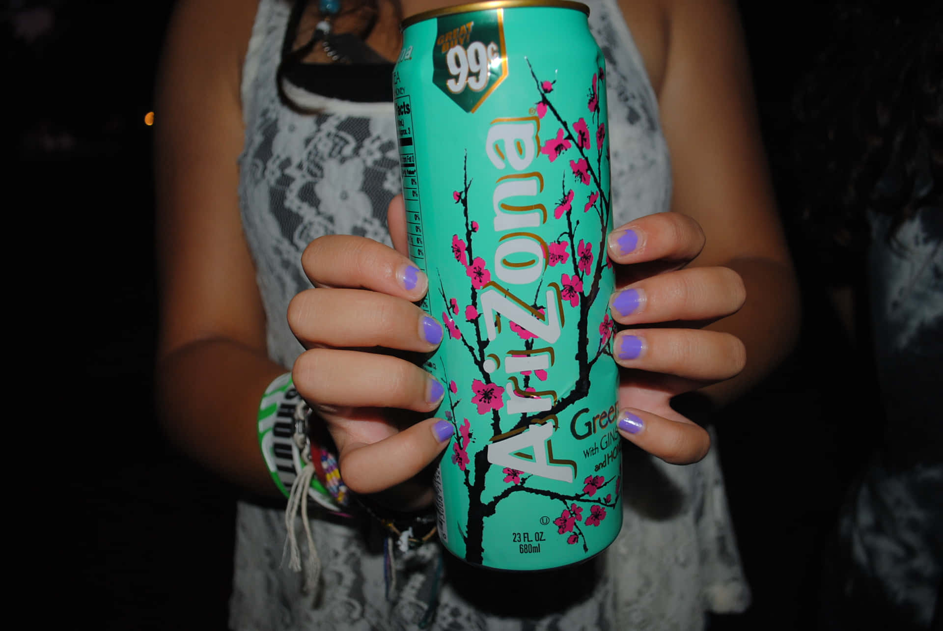A Woman Holding A Can Of Arizona Beer Background