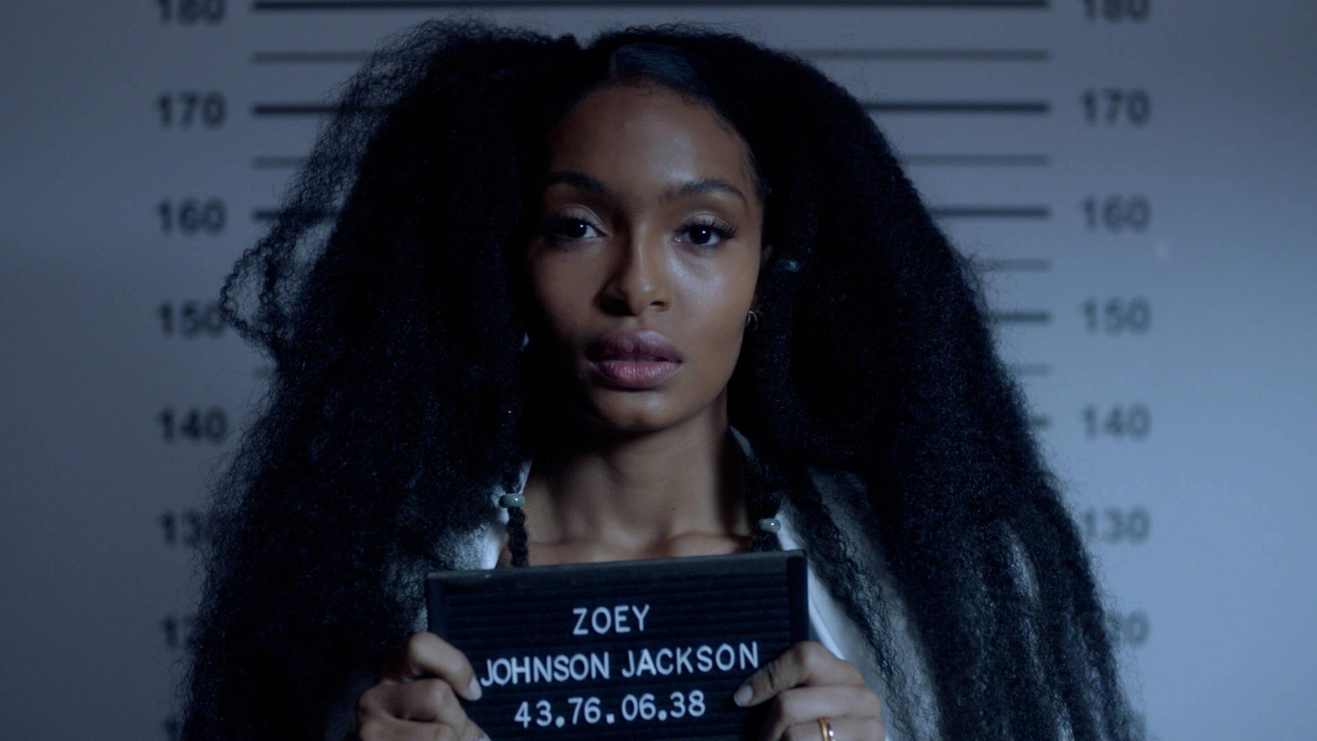 A Woman Holding A Mugshot In Front Of A Mugshot Background