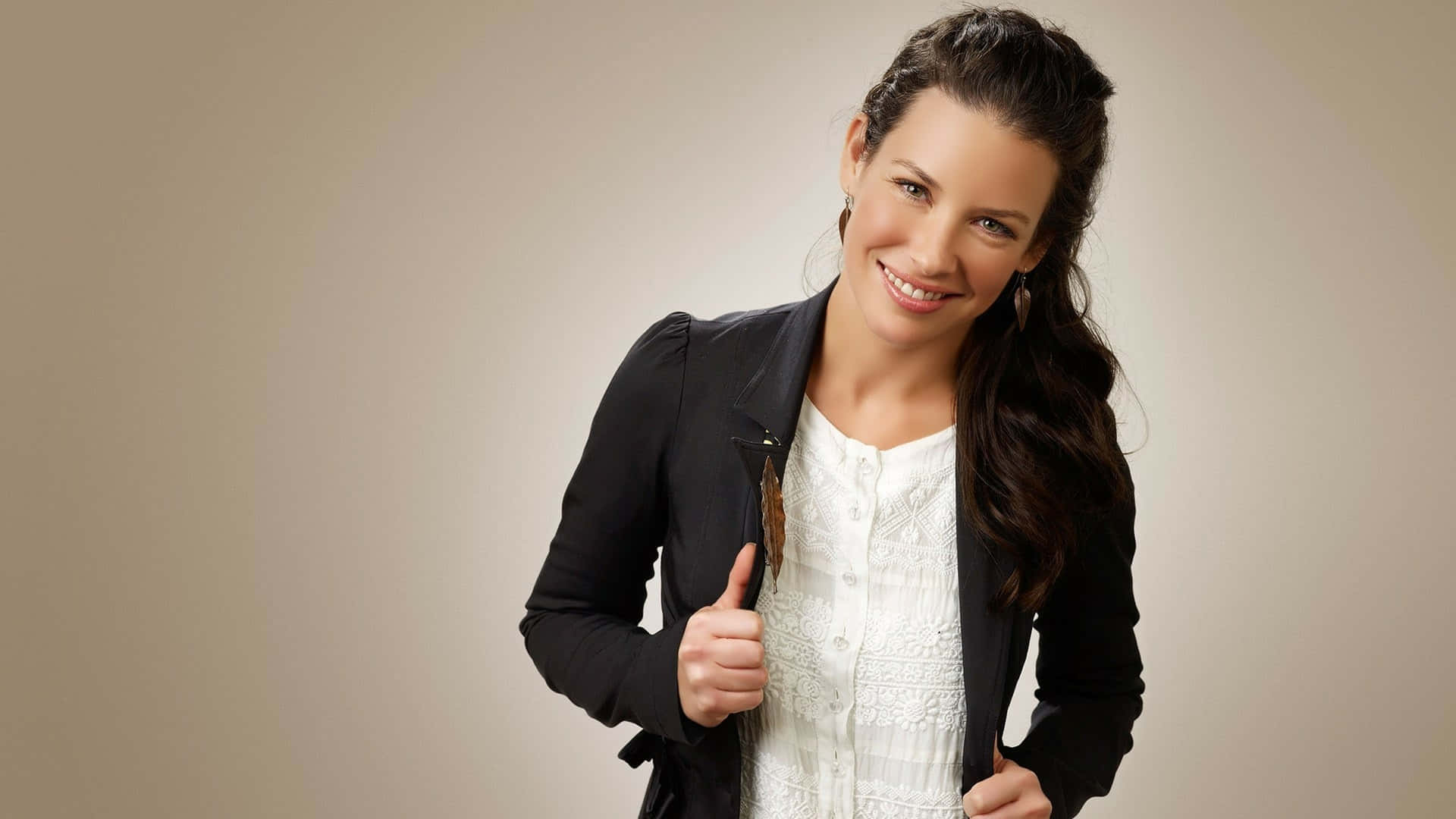 A Woman In A Black Jacket And White Shirt Posing Background