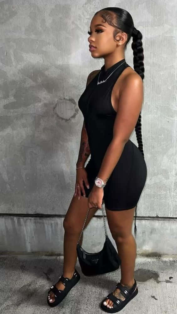 A Woman In A Black Sleeveless Romper