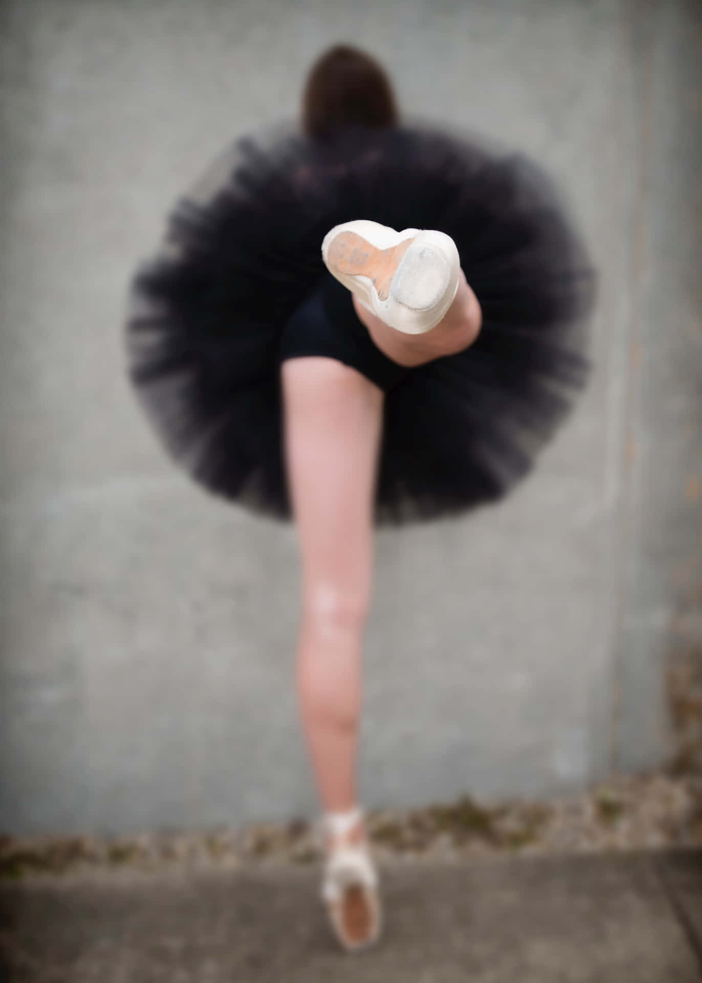 A Woman In A Black Tutu Is Posing Background