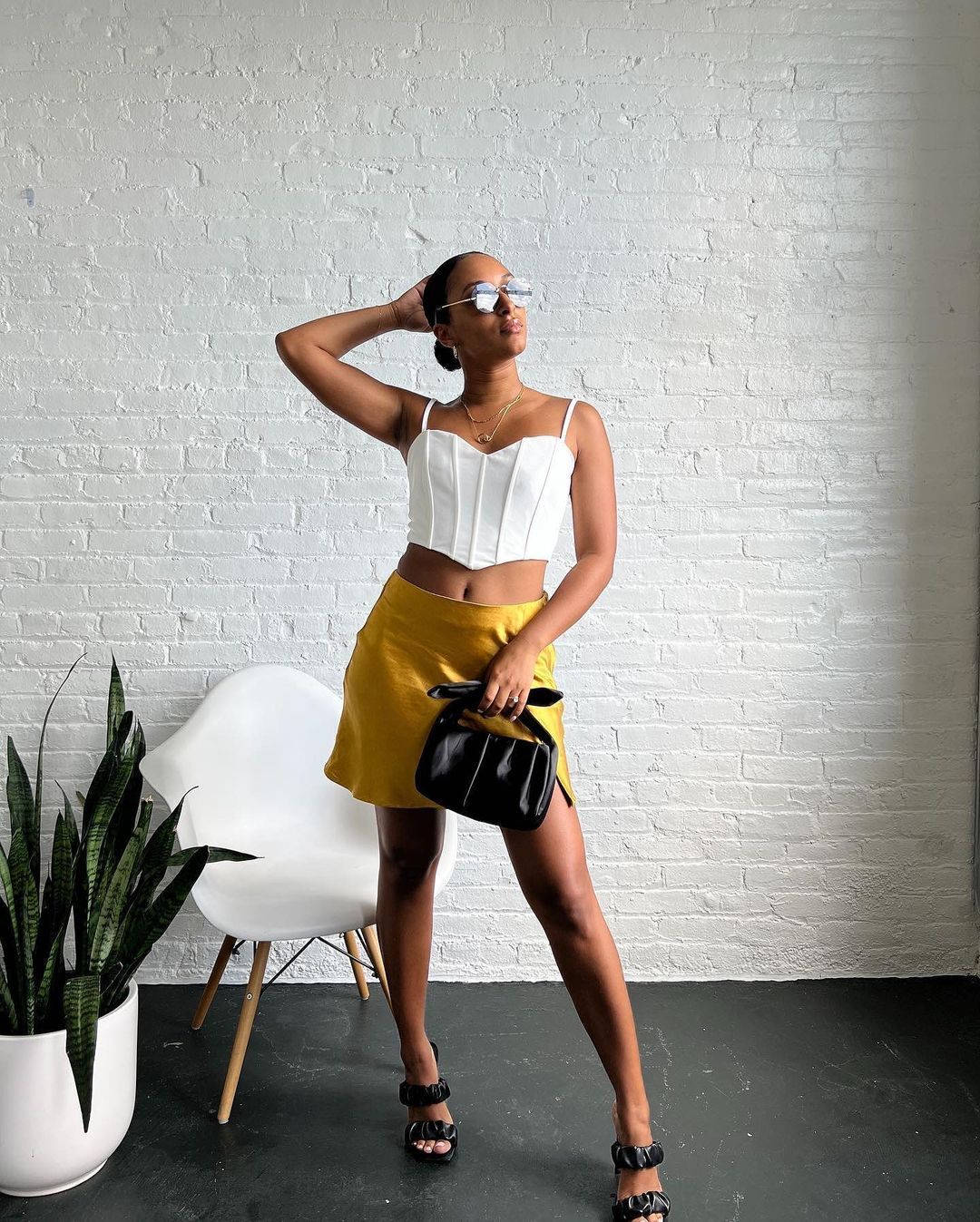 A Woman In A Yellow Skirt And White Top Background