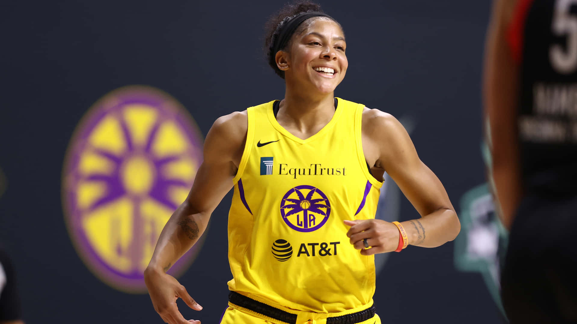 A Woman In A Yellow Uniform Is Smiling