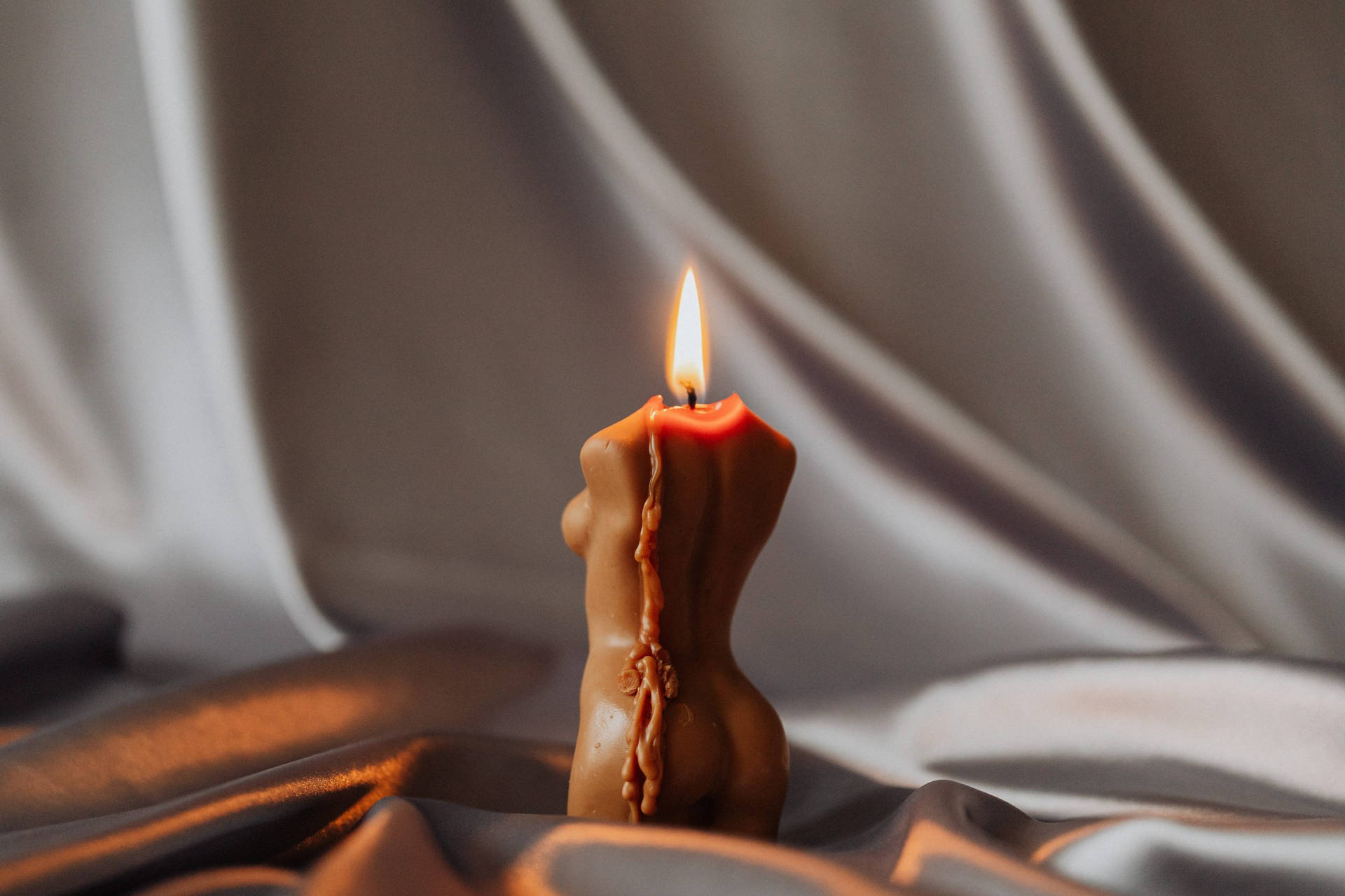 A Woman In Tranquil Meditation With A Holistic Lit Candle. Background