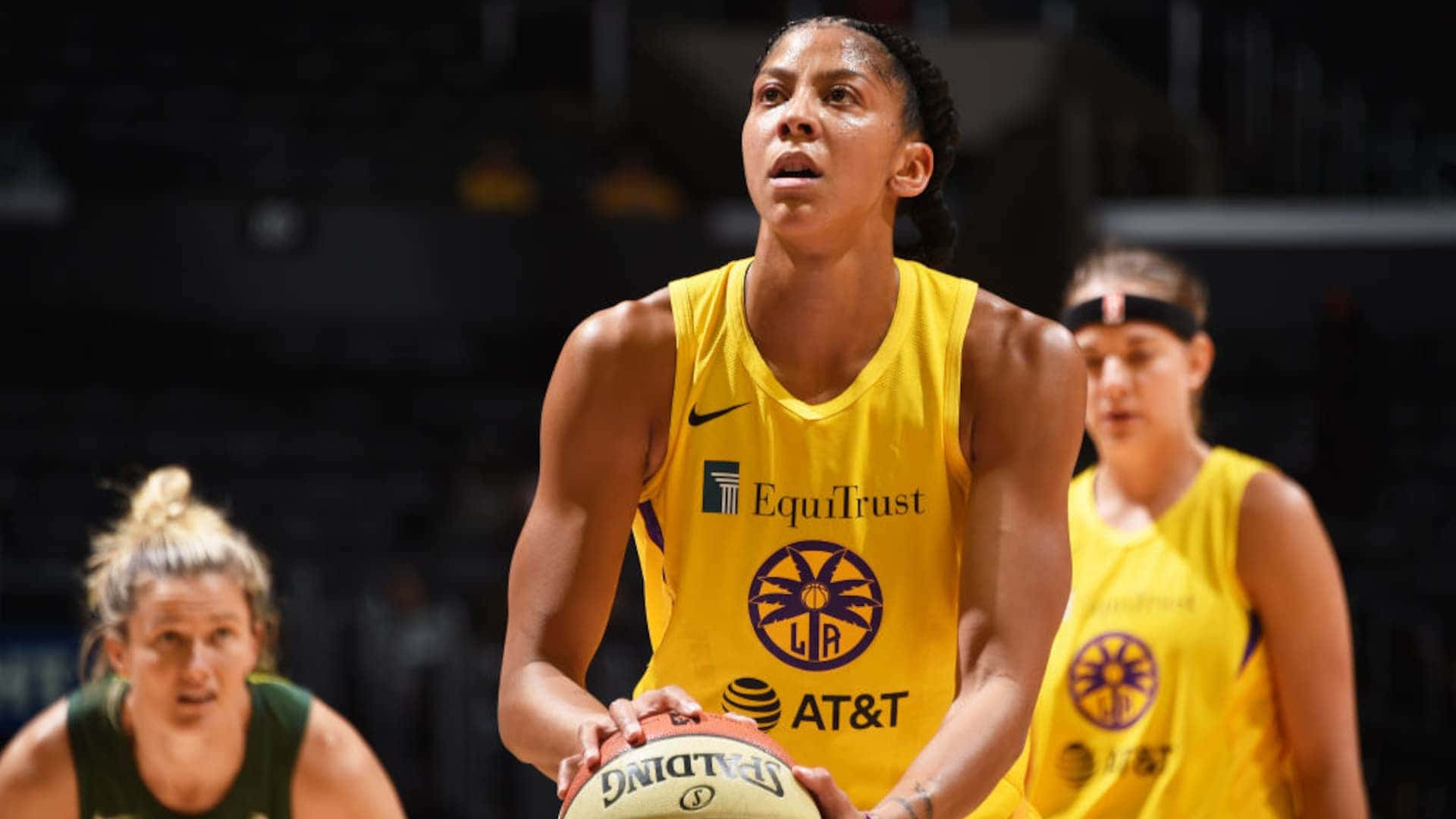 A Woman In Yellow Uniform Is Holding A Basketball Background