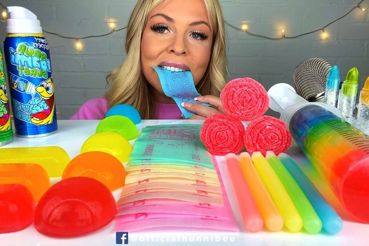 A Woman Is Eating Gum With A Toothbrush Background