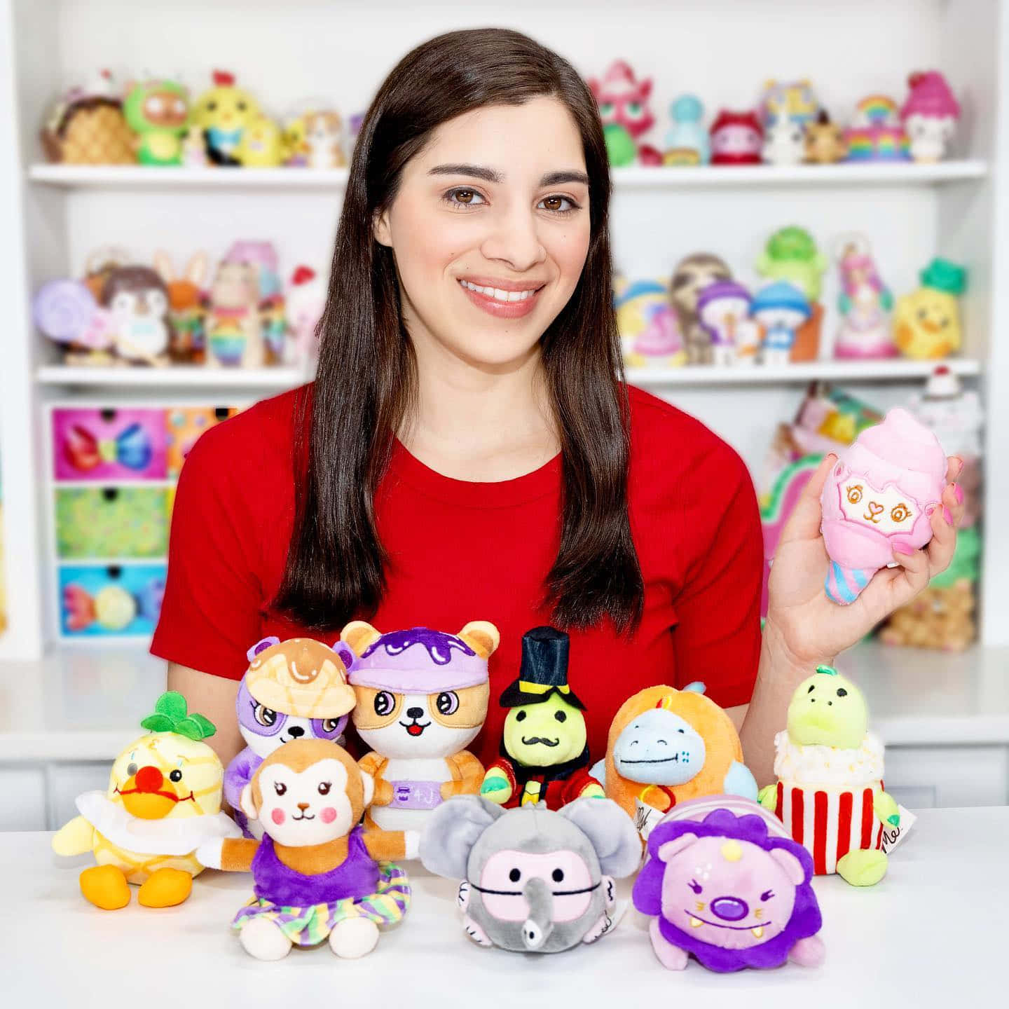 A Woman Is Holding A Bunch Of Stuffed Animals Background