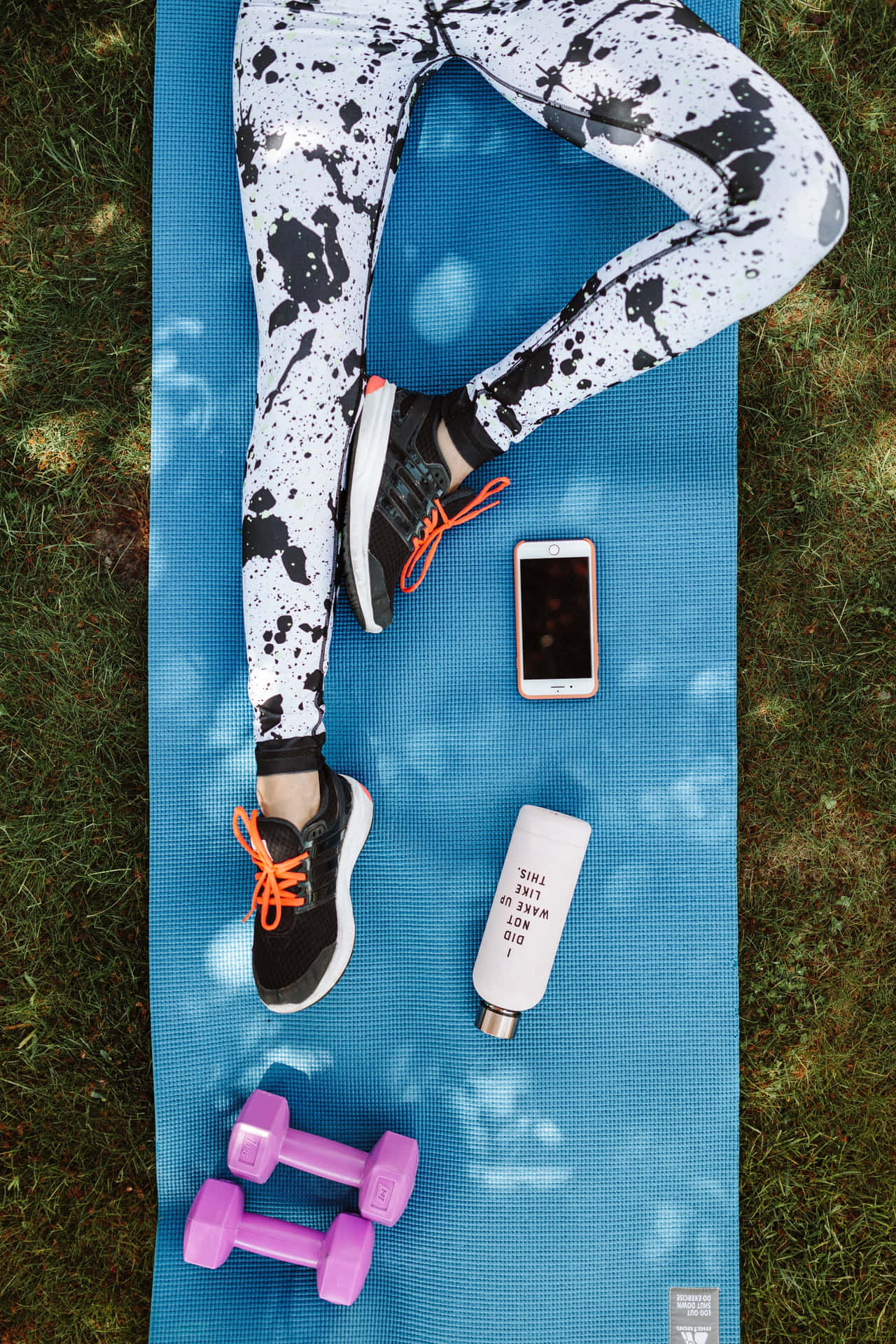 A Woman Is Laying On A Blue Mat Background