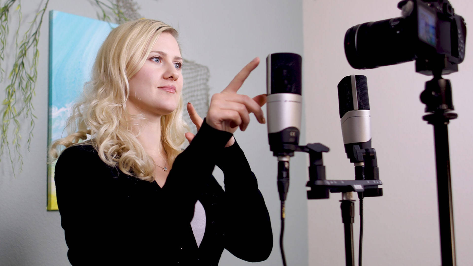 A Woman Is Pointing At A Microphone Background