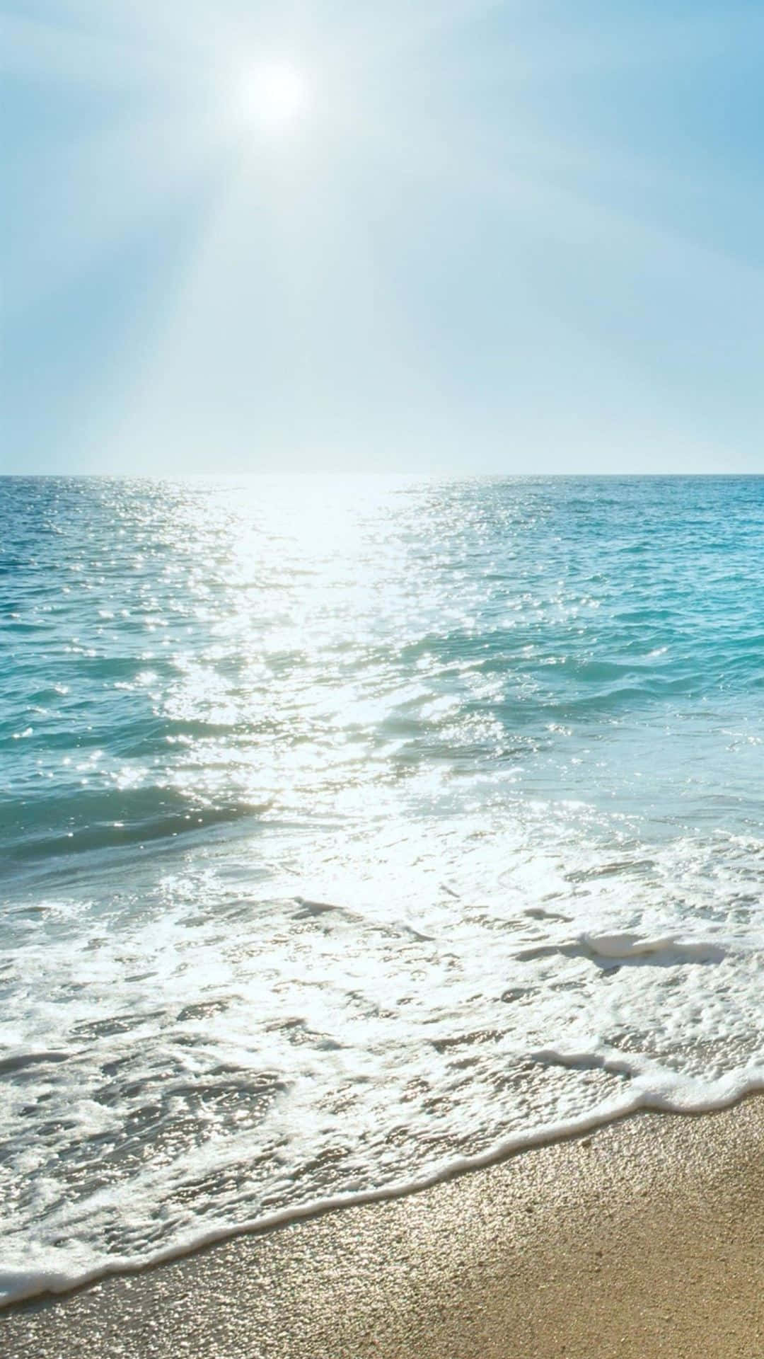 A Woman Is Sitting On A Beach With The Sun Shining On Her Background