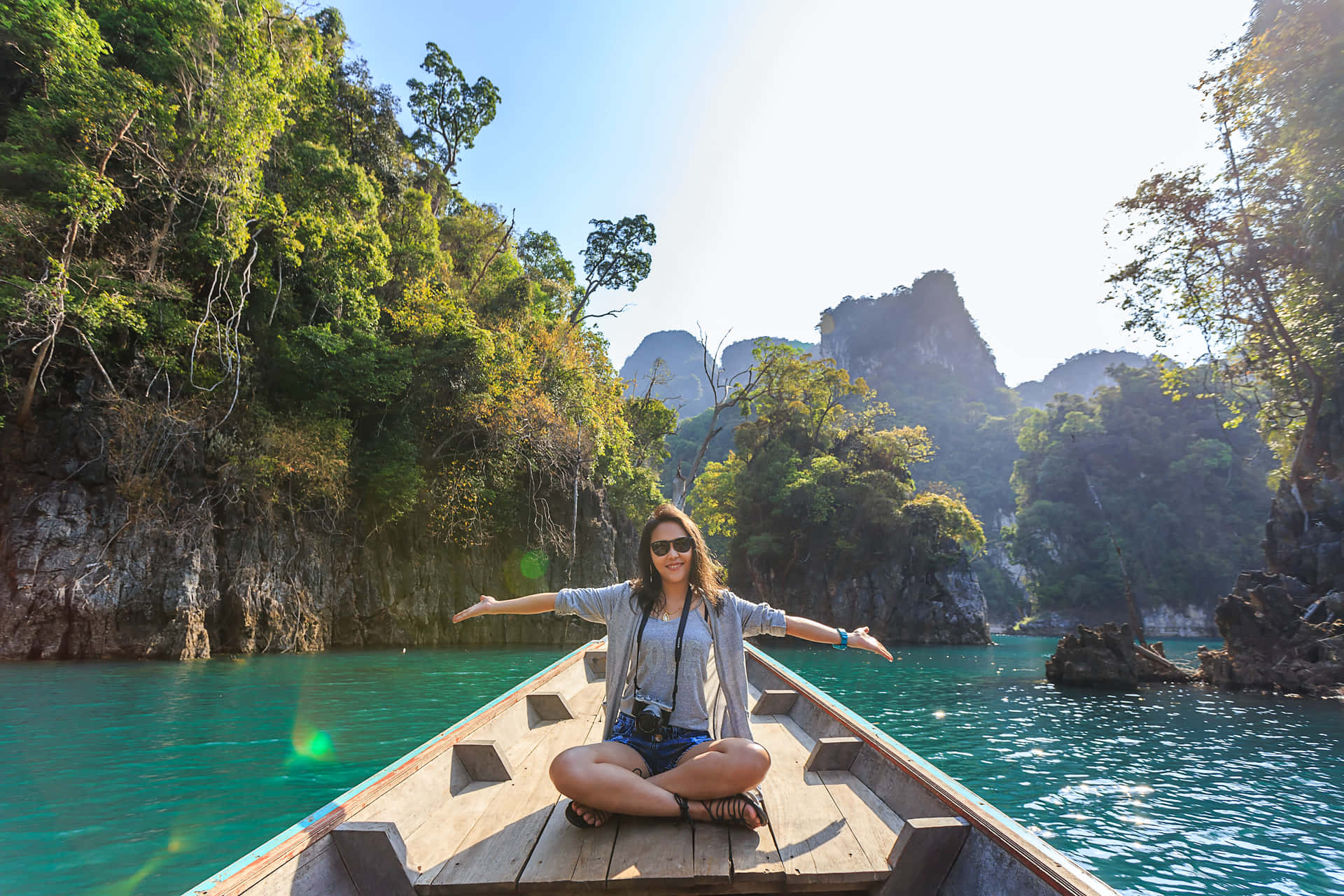 A Woman Is Sitting On A Boat In The Water Background