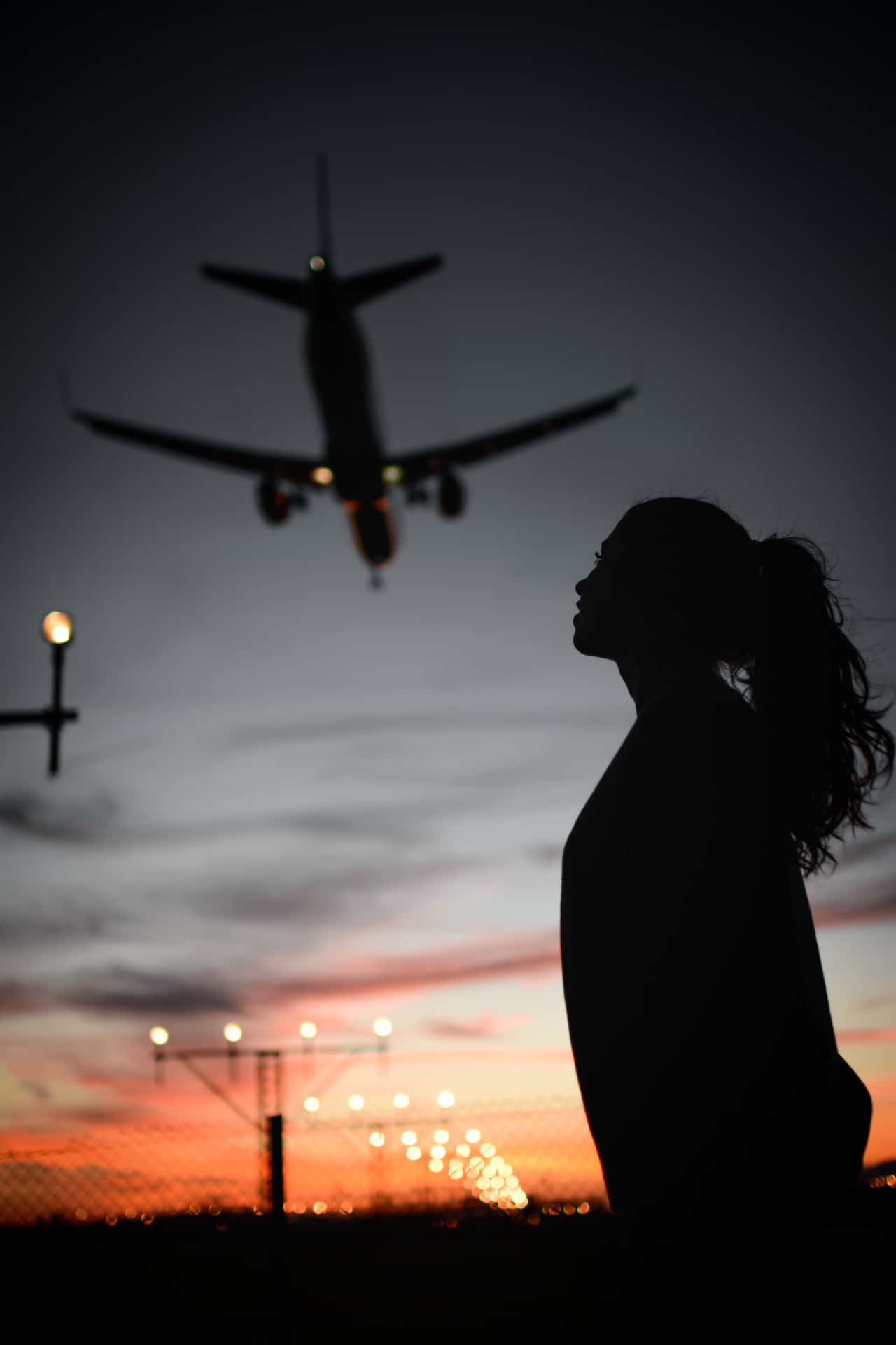 A Woman Is Standing In Front Of A Plane