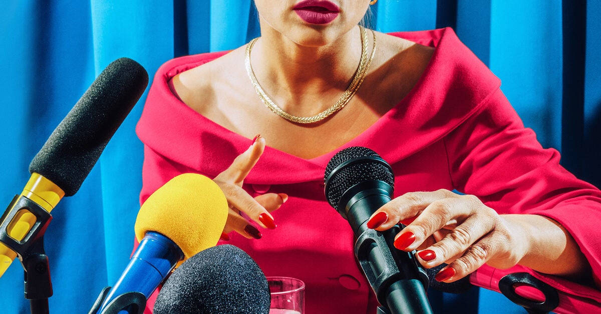 A Woman Is Talking To Microphones Background