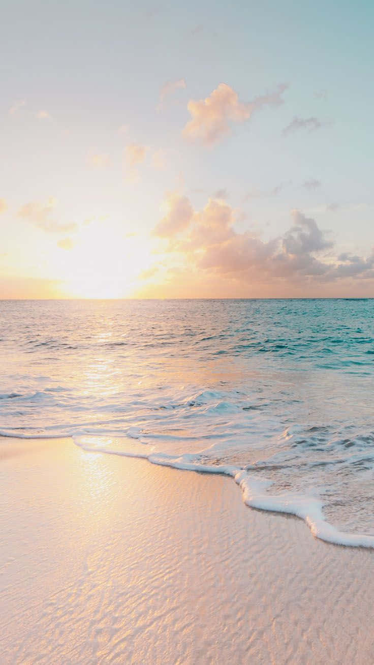 A Woman Is Walking On A Beach At Sunset Background