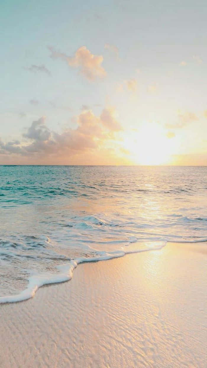 A Woman Is Walking On A Beach At Sunset Background