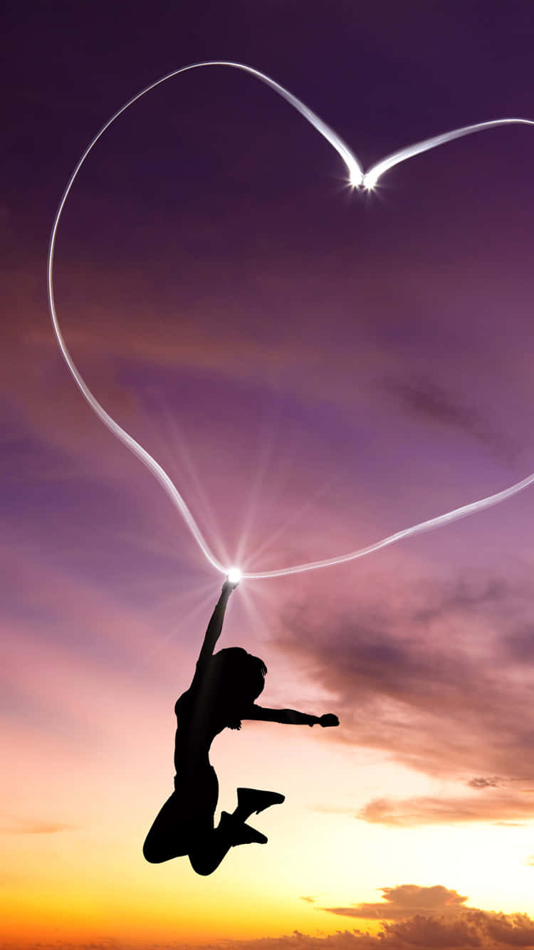 A Woman Jumping In The Air With A Heart Shaped Outline Background