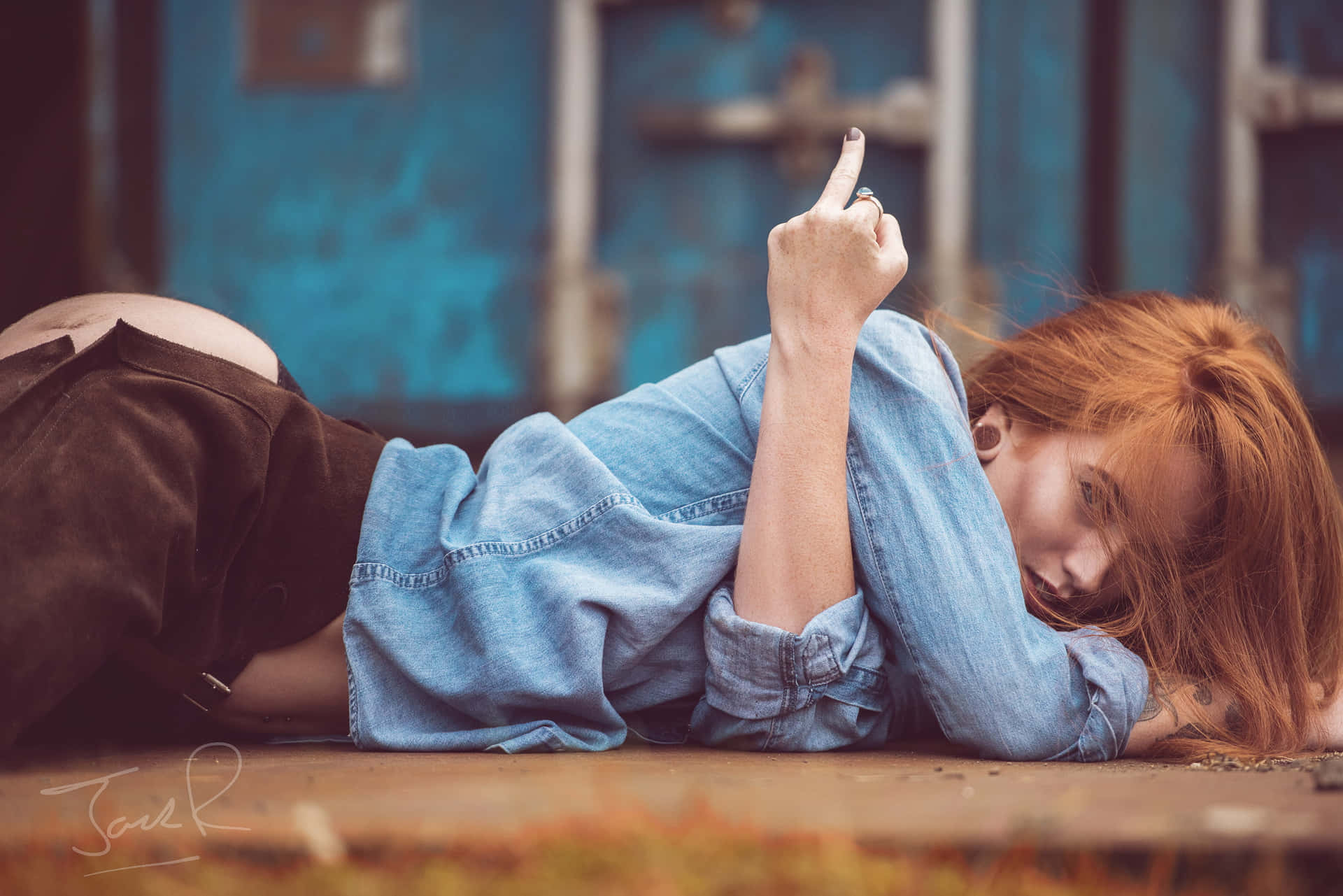 A Woman Laying On The Ground With Her Cigarette Background