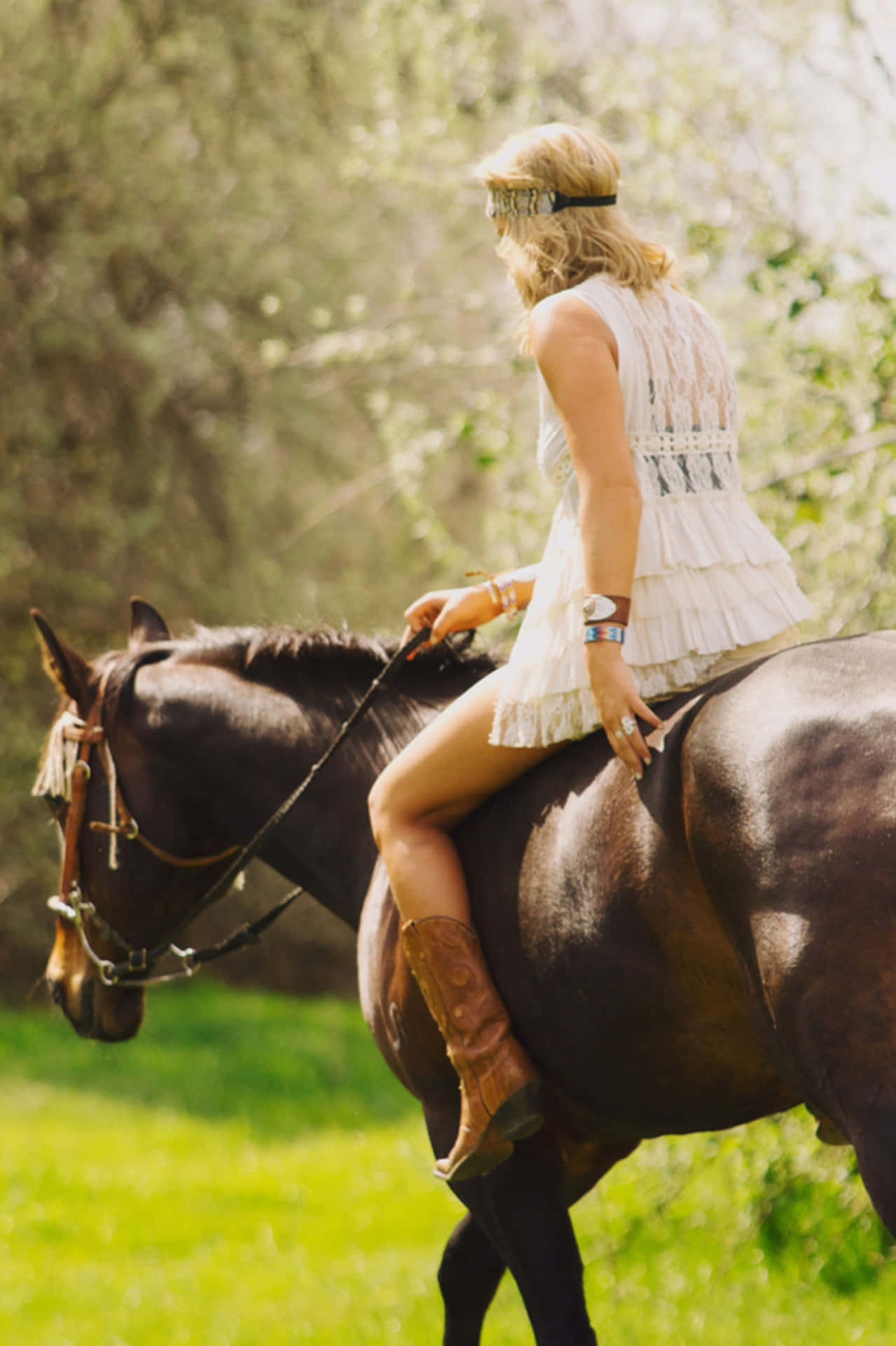 A Woman Riding A Horse In A Field Background