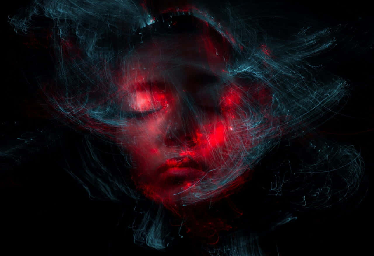 A Woman's Face With Red Light In The Background Background