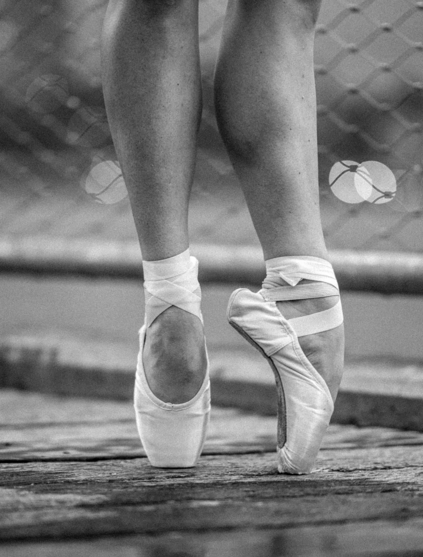A Woman's Feet In Ballet Shoes On A Dock Background