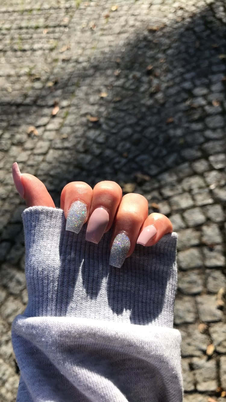 A Woman's Hand Holding A Sweater And Nails Background