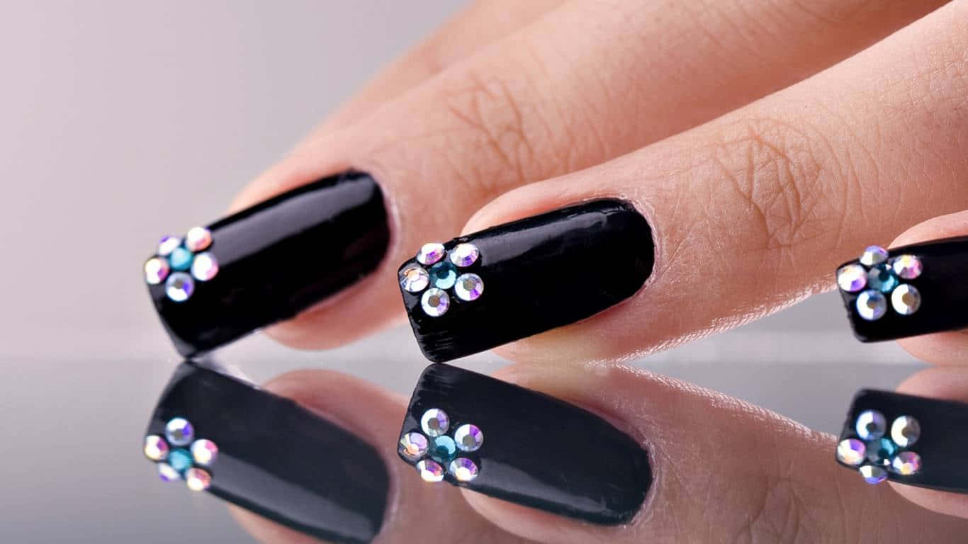 A Woman's Hand With Black Nails Decorated With Crystals Background