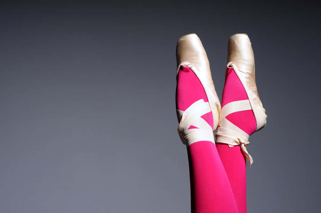 A Woman's Legs Are In Pink Ballet Shoes Background