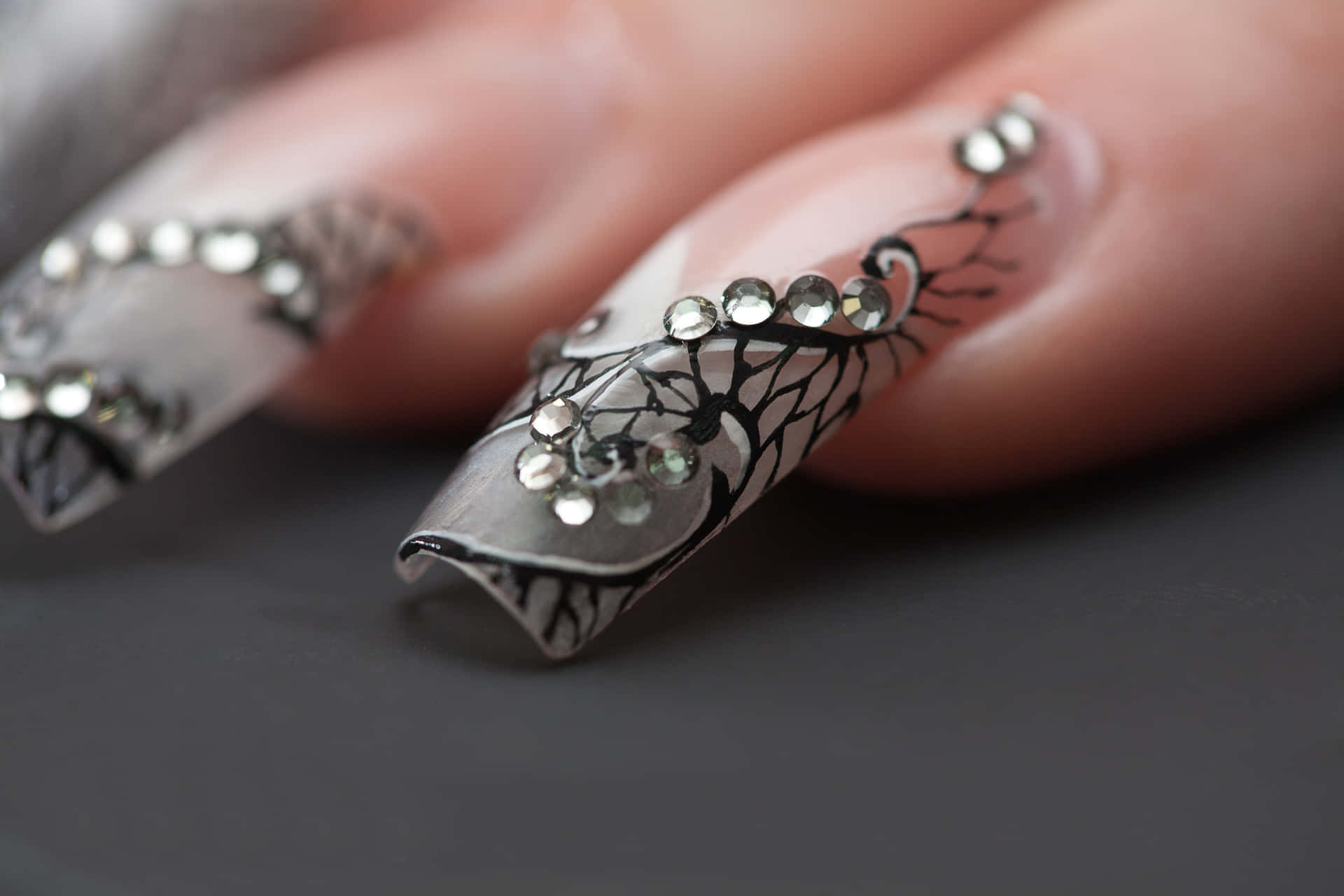 A Woman's Nails With A Lot Of Bling Background