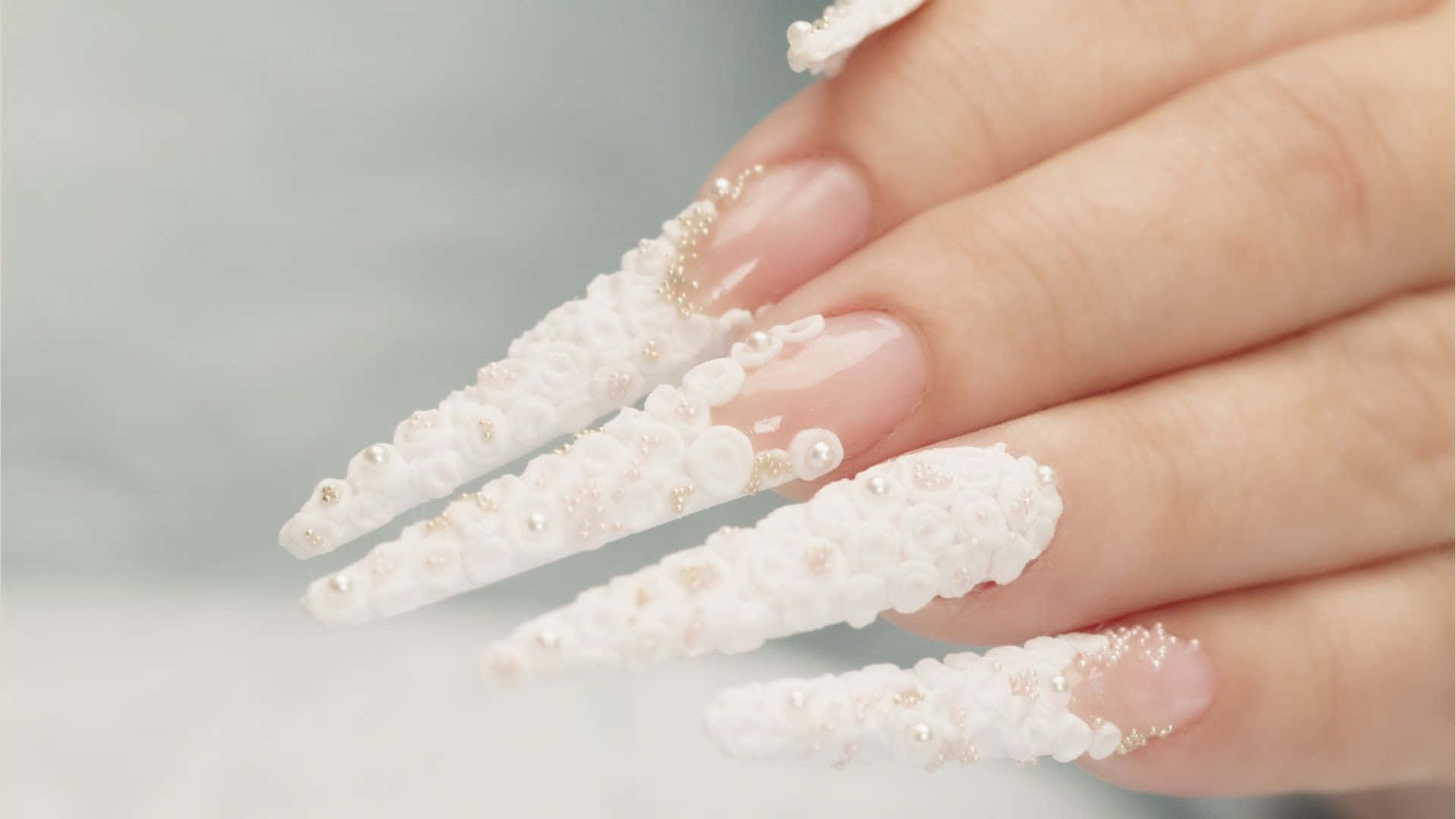 A Woman's Nails With White Pearls And Crystals Background