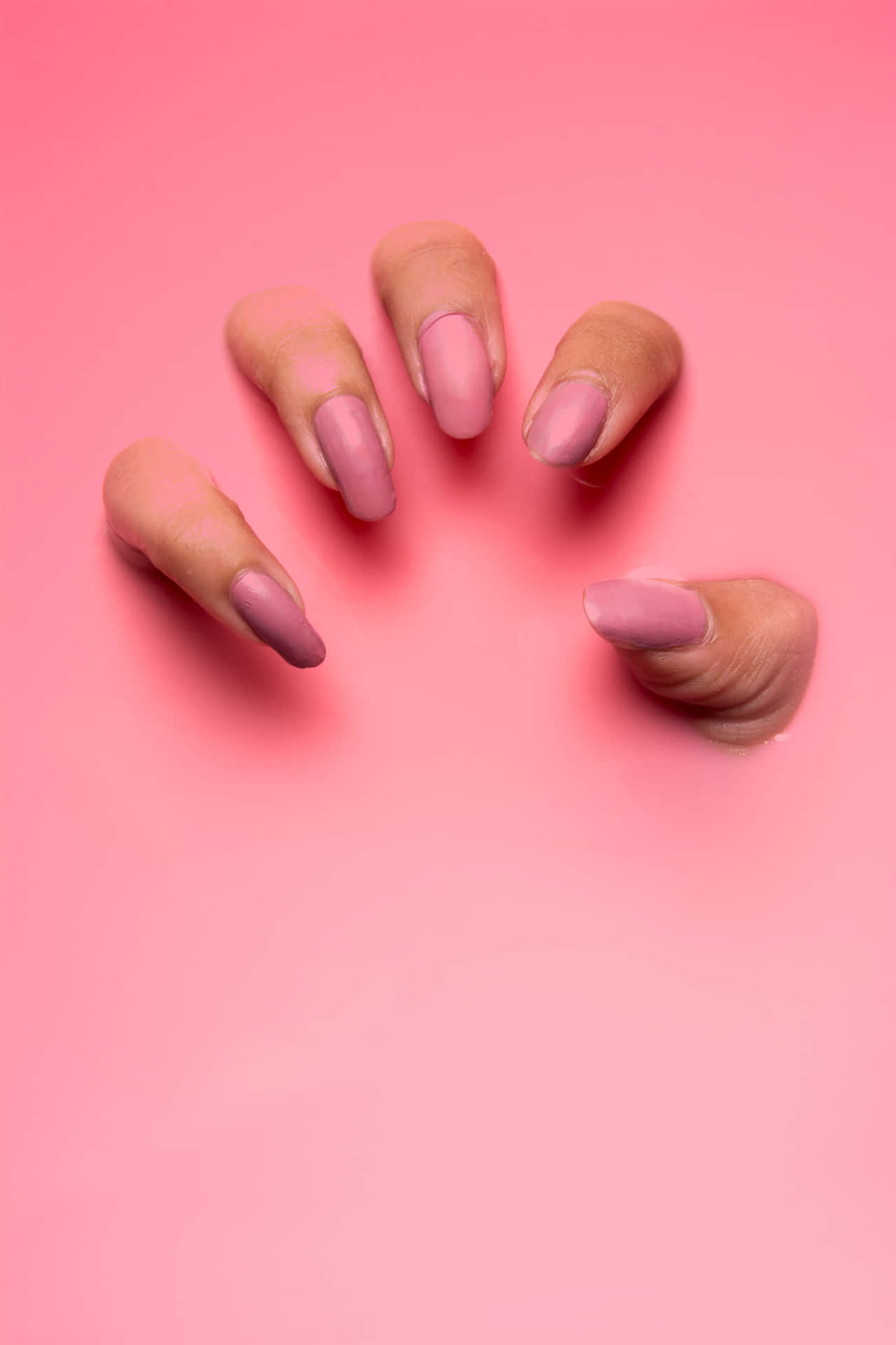 A Woman's Pink Nails Are Shown On A Pink Background Background