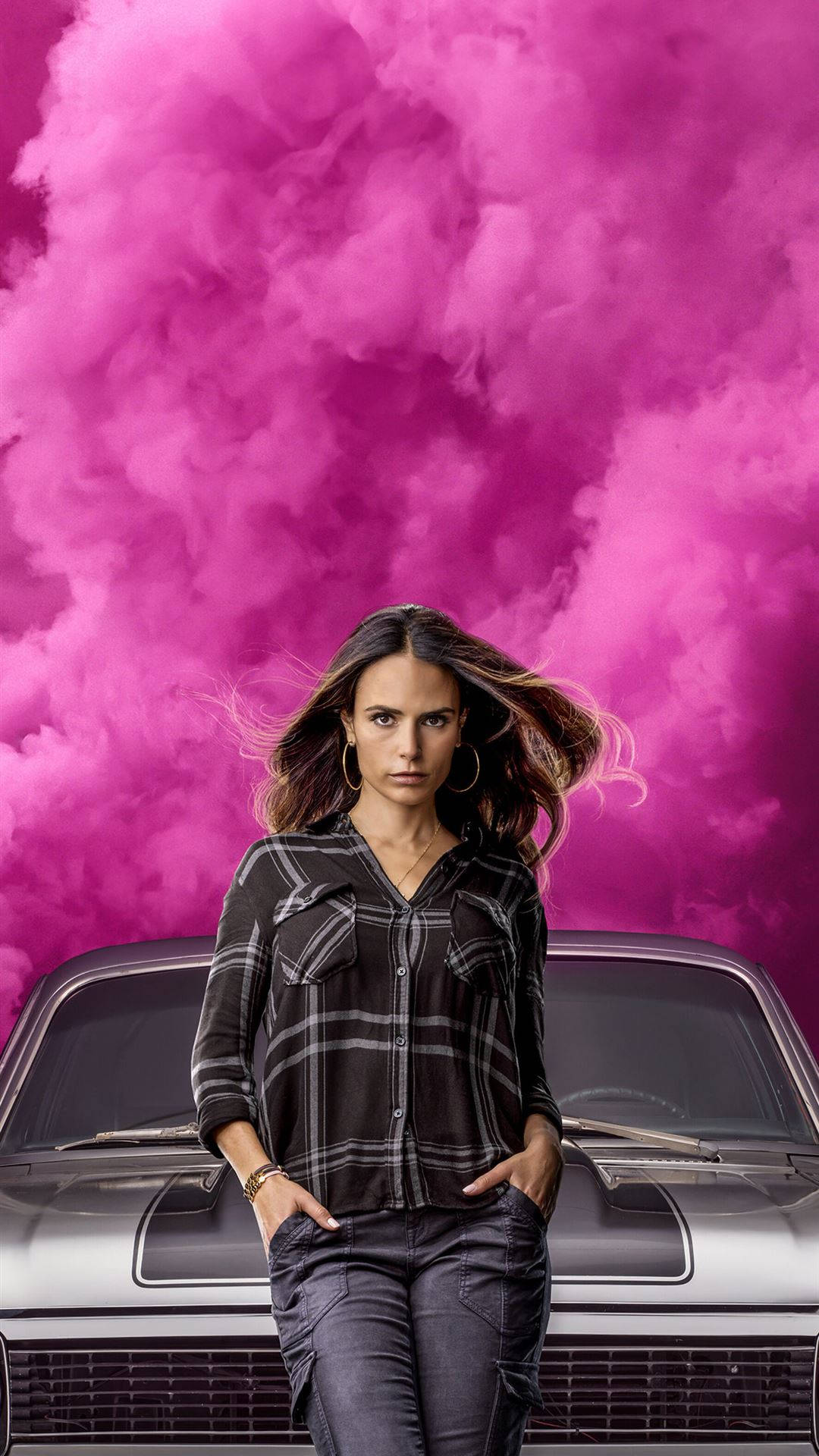 A Woman Standing Next To A Car With Pink Clouds Background