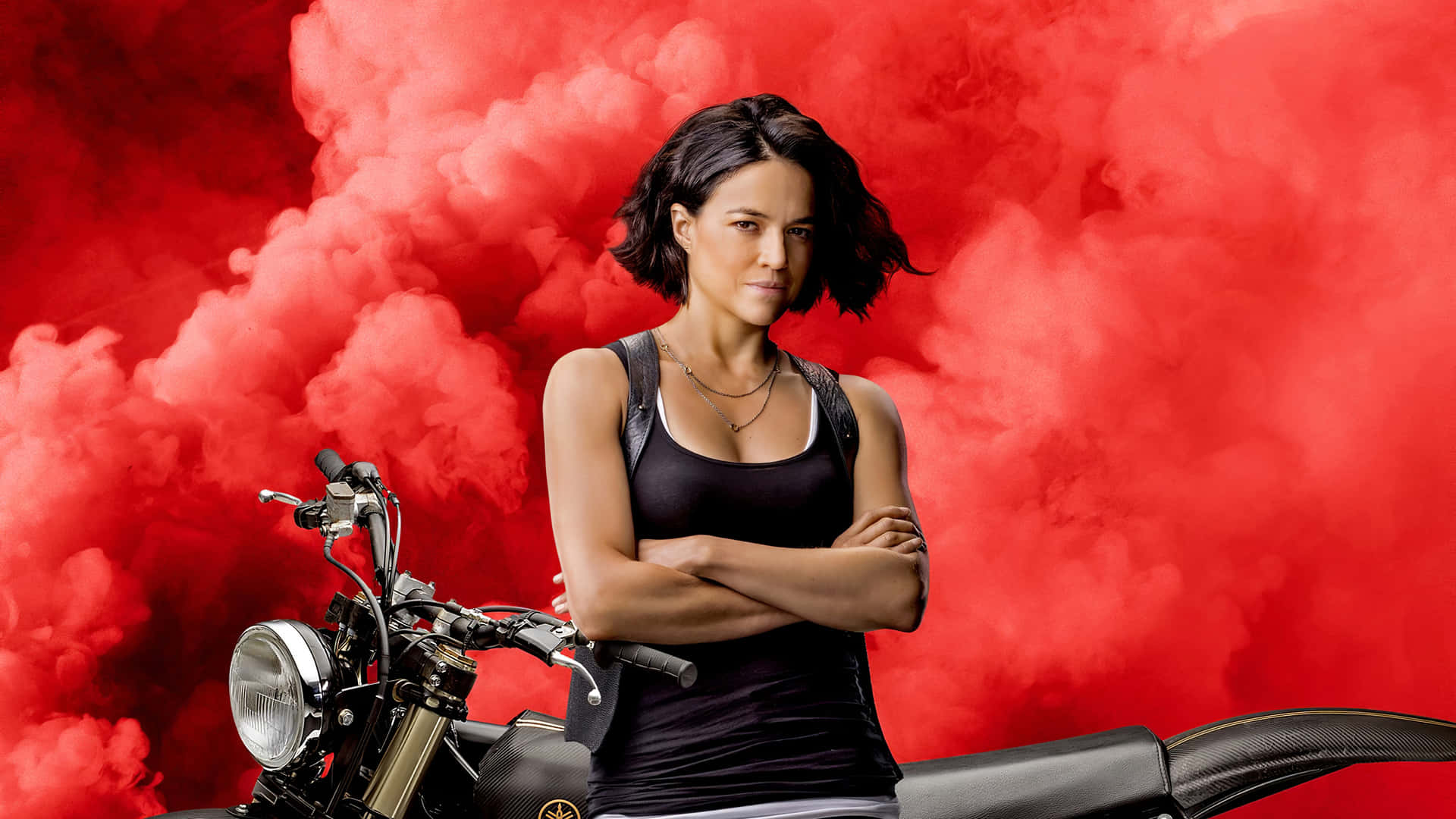 A Woman Standing On A Motorcycle With Smoke Coming Out Of It Background