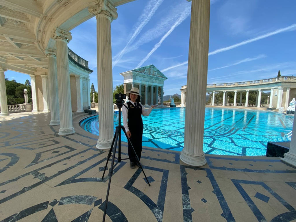 A Woman Taking Her Picture At Hearst Castle's Pool Background