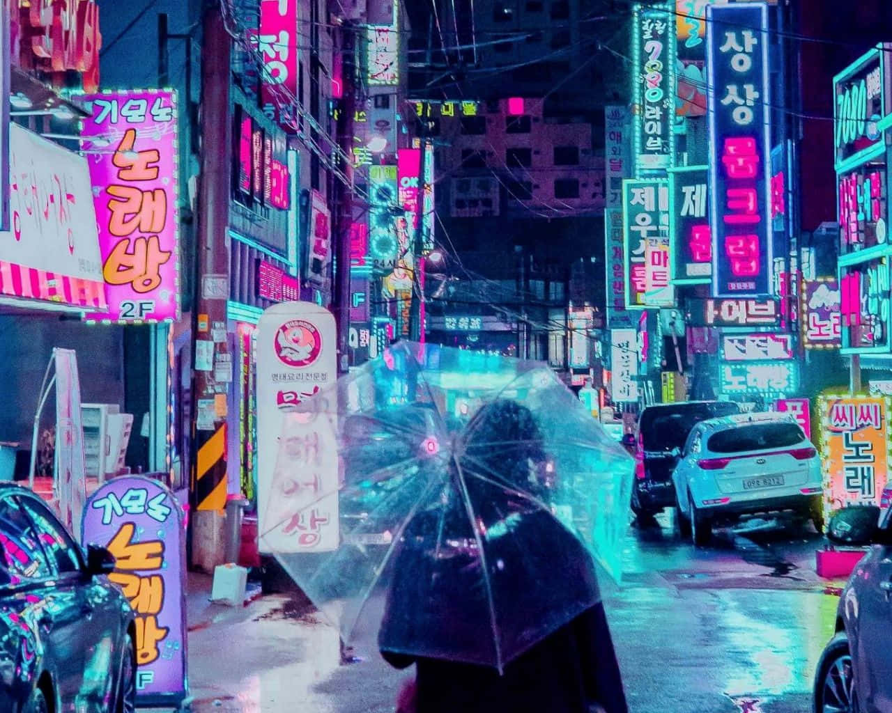 A Woman Walking Down A Street With Neon Signs Background