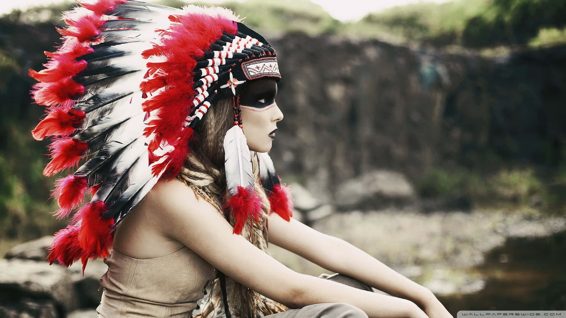 A Woman Wearing A Native American Headdress Background