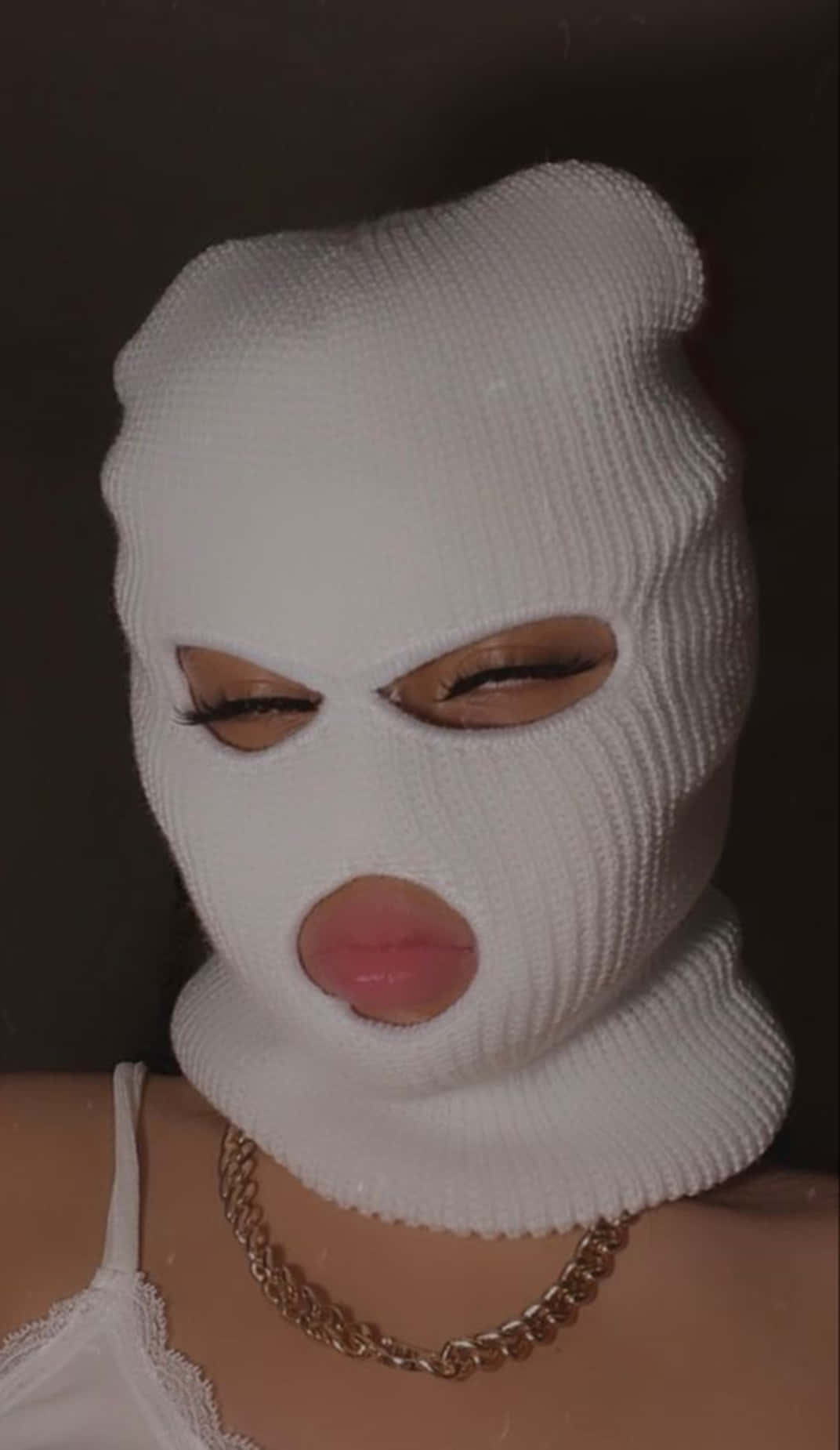 A Woman Wearing A White Knitted Mask