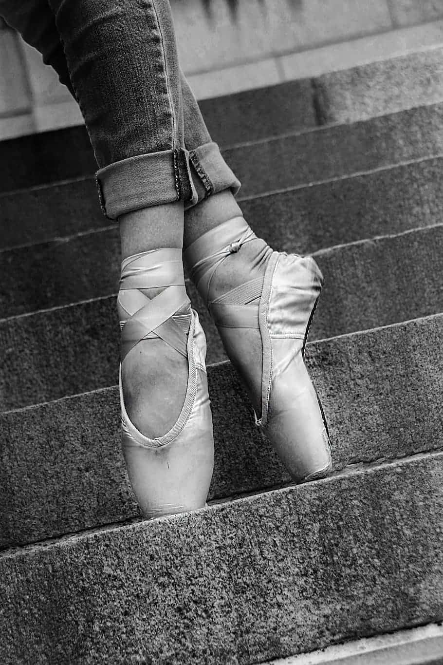 A Woman Wearing Ballet Shoes On The Steps Background